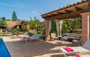 a patio with lounge chairs and a swimming pool at Sa Plana Port Nou in Cala Millor