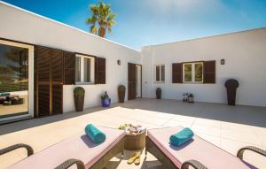 a patio with two beds and chairs on a patio at Robert Christopher Börner in Badia Gran