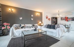 a living room with two white couches and a table at Atico Roger De Flor in Port de Pollensa