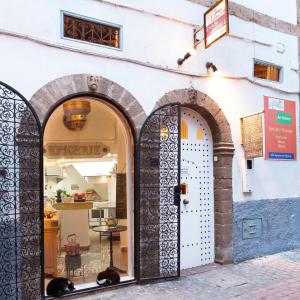 a store with arched doors in a street at Dar Adul in Essaouira