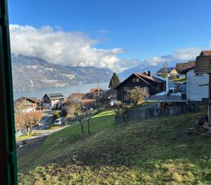 a view of a town with a lake and houses at Apartment Büel in Krattigen in Krattigen