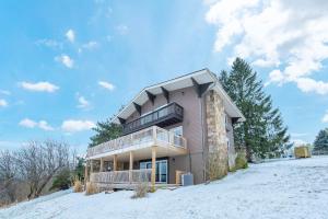 a house on top of a snow covered hill at As You Wish by Railey Vacations in Oakland