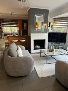 a living room with a couch and a fireplace at Villa Ariadni in Patra