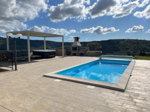 a swimming pool on a patio with a gazebo at Apartma Rozi Deluxe in Koper