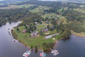 an island in the water with a house and a boat at As You Wish by Railey Vacations in Oakland +26 photos