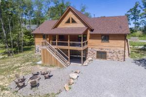 a log home with a deck and a patio at Aspen Summit by Railey Vacations in McHenry +63 photos