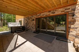 a patio with a wooden roof and glass doors at Aspen Summit by Railey Vacations in McHenry
