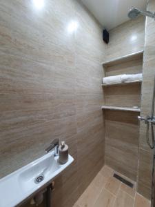 a bathroom with a sink and a shower at Dar AWRABIA in Fez +55 photos