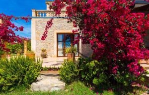 a house with red flowers in front of it at Etv4268, Casa Tolo in Son Servera