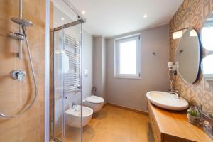 a bathroom with a shower and a toilet and a sink at B&B Portorosso in Monopoli