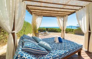 a bed in a room with a view of the beach at Sa Platja in Playa de Muro