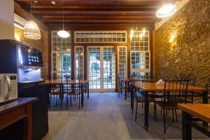 a dining room with tables and chairs in a restaurant at Pousada Aconchego in Paraty