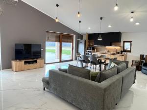 a living room with a couch and a table with chairs at Apartma Rozi Deluxe in Koper