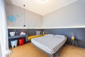 a bedroom with a bed in a room with blue walls at B&B Portorosso in Monopoli