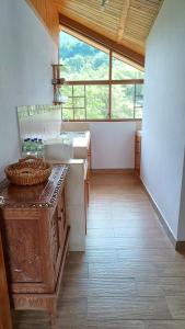 a large kitchen with a sink and a window at Mindo Suites - Rufous in Mindo