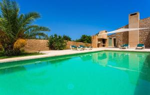 a large swimming pool with chairs and a house at Clovetes in Son Servera +44 photos