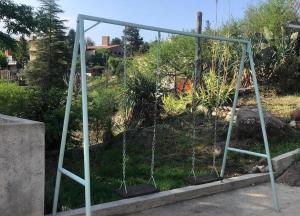 an empty swing set in a garden at Casa- alojamiento Gerez in San Antonio de Arredondo +4 photos