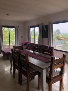 a dining room with a table and chairs and a couch at Casa- alojamiento Gerez in San Antonio de Arredondo
