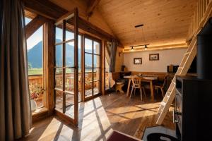 a room with a large window and a table at Chalet Herbst in Lofer