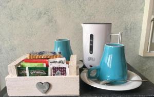 a table with two blue mugs and a box of treats at Bed & Breakfast Carpe Diem in Solferino +8 photos