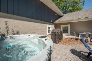 a hot tub in a yard next to a house at Ballers Bungalow by Railey Vacations in Swanton