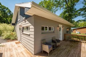 a small shed with two chairs on a deck at Ballers Bungalow by Railey Vacations in Swanton