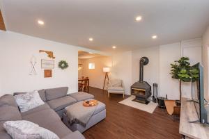 a living room with a couch and a fireplace at Ballers Bungalow by Railey Vacations in Swanton