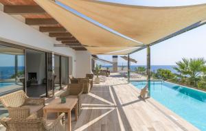 a villa with a swimming pool and a patio at Lifetime in Font de Sa Cala