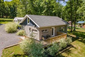 a tiny house with a porch in a yard at Ballers Bungalow by Railey Vacations in Swanton