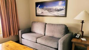 a living room with a couch and a picture on the wall at Cahilty #103 in Sun Peaks