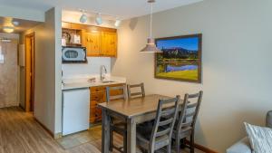 a kitchen and dining room with a table and chairs at Cahilty #204 home in Sun Peaks