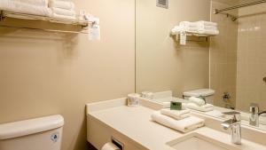 a bathroom with a sink and a toilet and a mirror at Cahilty #204 home in Sun Peaks