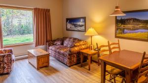 a living room with a couch and a table at Cahilty #103 in Sun Peaks