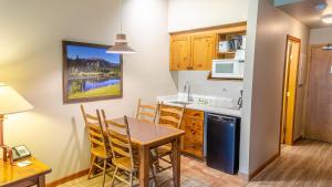 a kitchen and dining room with a table and chairs at Cahilty #103 in Sun Peaks