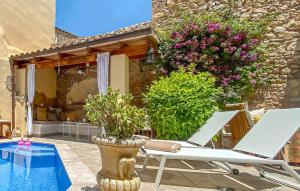a patio with two lounge chairs and a pool at Casa Vida Arta in Artá
