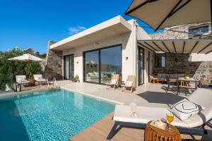 a house with a swimming pool and a patio at Majestic View Villas in Agios Nikolaos