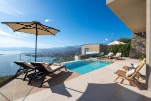 a villa with a swimming pool and a patio at Majestic View Villas in Agios Nikolaos