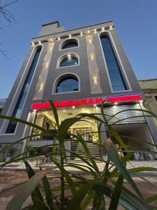 a building with lights on the side of it at The Hotel Sundaram Continental in Prayagraj