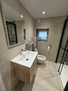 a bathroom with a sink and a toilet at Le Nid de Chartreuse in Saint-Christophe +14 photos