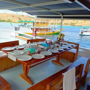 a table on a boat in the water at Sharing trip komodo 3d 2n in Labuan Bajo