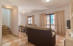 a living room with a couch and a dining room at Roser De Arta in Artá