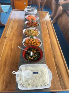 a table with several plates of food on it at Sharing trip komodo 3d 2n in Labuan Bajo