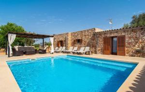 a swimming pool in front of a villa at S'hortet in Campos