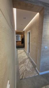 a hallway of a house with a marble floor at Apartman Nadja in Šabac +10 photos