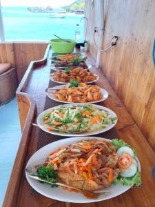 a buffet with plates of food on a table at Sharing trip komodo 3d 2n in Labuan Bajo