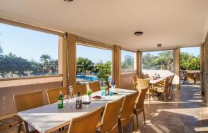 a restaurant with tables and chairs and large windows at Finca Sa Pedrera in Can Picafort