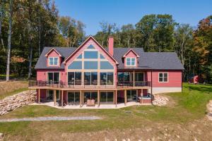a large red house with a large deck at Bear Cliff Lodge by Railey Vacations in Friendsville