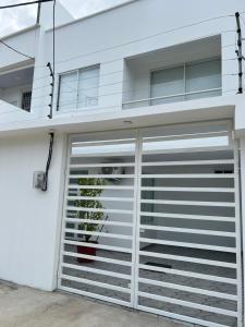 a garage door opener on a white house at Alma del Mar in Volcán Chimborazo