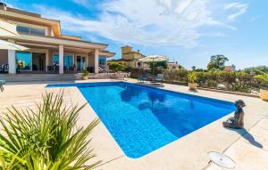 a swimming pool in front of a house at Redrema in Llucmajor