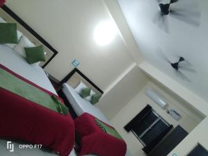 a bedroom with red and green pillows on a bed at Hotel Sunshine in Konārka